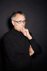 Image showing Senior man, thinking and ideas with decision, choice and confident guy on a dark studio background. Mature person, mockup space and model with glasses, wonder and thoughts with planning or retirement