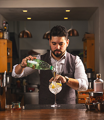 Image showing Bartender preparing cocktail