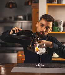 Image showing Professional barman using jigger