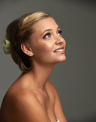 Image showing Thinking, smile and woman with cosmetics, beauty and wellness on a grey studio background. Person, girl and model with shine, skincare or grooming with texture, healthy skin and dermatology with glow