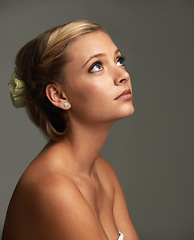 Image showing Thinking, glow and woman with cosmetics, dermatology and luxury on a grey studio background. Person, girl and model with shine, natural beauty and grooming with texture, healthy skin and wellness