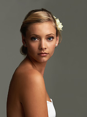 Image showing Portrait, cosmetics and woman with natural beauty, flowers and shine isolated on grey studio background. Face, person and model with texture, skincare and grooming with aesthetic and healthy skin