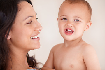 Image showing Family, relax and mother with baby on a white background for bonding, relationship and happy together. Love, youth and portrait of mom carrying kid for growth, playing and child development in studio