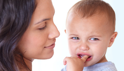 Image showing Family, crying and mother with baby on a white background for bonding, empathy and comfort. Love, youth and mom with sad or upset kid for relationship, wellness and child development in studio