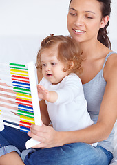 Image showing Abacus, math and girl baby with mom playing, learning and teaching for child development on bed. Bonding, toy and young mother teaching kid, infant or toddler with counting in bedroom at home.