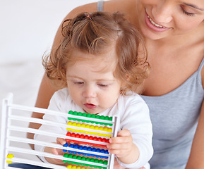 Image showing Abacus, math and toddler with mother playing, learning and teaching for child development on bed. Bonding, toy and closeup of mom teaching kid, infant or baby with counting in bedroom at home.