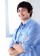 Image showing Happy man, portrait and office by window with arms crossed in confidence for career ambition. Face of young handsome male person or professional employee smile with positive attitude at workplace