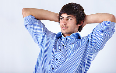 Image showing Happy man, relax and sitting back at office on break for done, completion or finished on a white studio background. Face of young handsome male person or employee in rest with blue t shirt on mockup