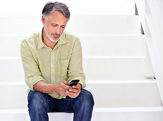 Image showing Business, man or phone on stairs in office for social network, download digital app or contact in agency. Mature entrepreneur typing on smartphone, reading mobile notification or search news on steps