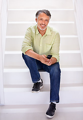 Image showing Man, portrait or phone on stairs in office for social network, download digital app or business contact in agency. Happy mature entrepreneur typing on smartphone, mobile notification or chat on steps