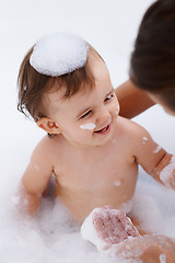 Image showing Baby, person and laughing while washing in bath, foam soap and cleaning for skincare at home. Happy girl, toddler and childcare or water for prevention of bacteria and virus, cosmetics and liquid