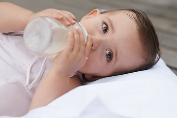 Image showing Baby, kid and drinking bottle for nutrition, liquid food and relaxing together on porch at home. Girl, toddler and formula for health or child development in outdoors, feeding and milk for wellness