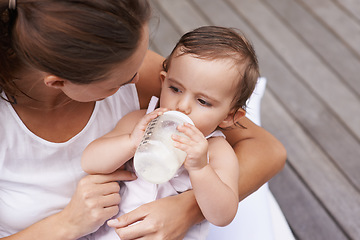 Image showing Baby, mother and drinking formula for nutrition, food and relaxing together on porch at home. Mommy, toddler and bottle for health or child development in outdoors, feeding and milk for wellness