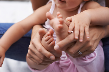 Image showing Baby, feet and mom hands with love, bonding and child care with parenting and youth outdoor. Family, support and young kid with newborn, holding and barefoot with trust, toddler and relax with mother