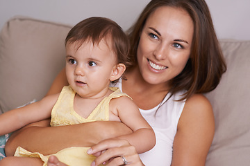 Image showing Mother, baby and hug in living room for love, smile and affection or bonding in childhood. Mom, toddler and happy girl or child and relaxing on couch, embrace and security in relationship and care