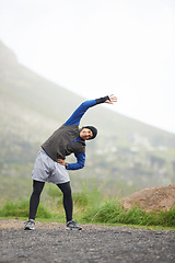 Image showing Man, stretching and prepare for fitness outdoor, mountain and nature with runner and start exercise. Workout, training and warm up in road, ready for race or cardio with endurance for health
