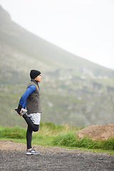 Image showing Man, stretching legs and fitness outdoor, running on mountain and nature with runner and start exercise. Workout, training and warm up in road, ready for race or cardio with endurance for health