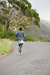 Image showing Back, fitness and man running in the road for morning cardio, training or marathon. Health, sports and a person, athlete or male runner in street for a triathlon, active or exercise for competition