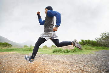 Image showing Fitness, runner and man running in nature training, cardio exercise and endurance workout for wellness. Sports, challenge or healthy male athlete on fast jog on path outdoors with speed or action