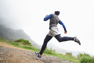 Image showing Low angle, fitness and man running in nature training, cardio exercise or endurance workout for wellness. Sports, runner or back of healthy athlete on fast jog on path outdoors with speed or action