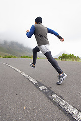 Image showing Back, fitness and man running on road in training, cardio exercise or endurance workout for wellness. Sports, runner or healthy athlete on fast jog on path outdoors with speed, challenge or action