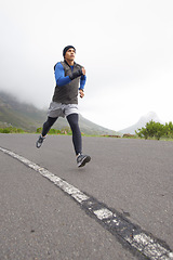 Image showing Sports, fitness and man running on road in training, cardio exercise or endurance workout for wellness. Energy, runner or healthy male athlete on fast jog outdoors with speed, challenge or action