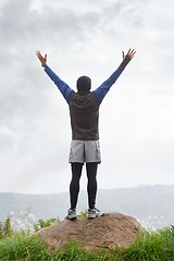 Image showing Man, runner or victory on mountain peak for training adventure, exercise or workout success. Hill, fitness or back of hiker with hands up, gratitude or freedom in park to explore nature outdoors