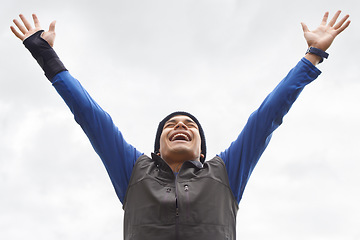 Image showing Happy man, runner or hands up for success in training adventure, exercise or workout victory. Excited, sky or healthy hiker with smile, gratitude or freedom for fitness to explore nature outdoors