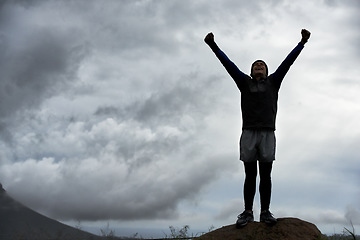 Image showing Happy man, mountain peak space or hands up for celebration in training, exercise or workout success. Excited athlete, sky mockup or hiker with energy, gratitude or freedom in nature for fitness