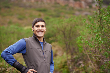 Image showing Earphones, runner or portrait of a happy man in forest for workout, exercise or fitness training in woods. Nature, confident sports person or healthy athlete with radio music audio, wellness or smile