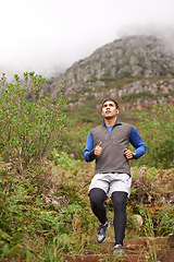 Image showing Steps, athlete and man running in nature training, cardio exercise and endurance workout for wellness. Sports, fitness or healthy runner on jog in forest, stairs or mountain trail outdoors in winter