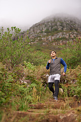 Image showing Steps, athlete walking and man in nature training, cardio exercise and endurance workout for wellness. Sports, fitness or healthy person on jog in forest, stairs or mountain trail outdoors in winter