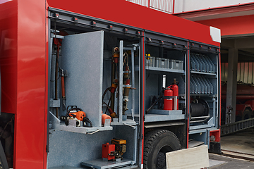 Image showing Close-up of essential firefighting equipment on a modern firetruck, showcasing tools and gear ready for emergency response to hazardous fire situations