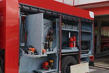 Image showing Close-up of essential firefighting equipment on a modern firetruck, showcasing tools and gear ready for emergency response to hazardous fire situations