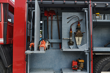 Image showing Close-up of essential firefighting equipment on a modern firetruck, showcasing tools and gear ready for emergency response to hazardous fire situations