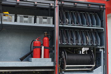 Image showing Close-up of essential firefighting equipment on a modern firetruck, showcasing tools and gear ready for emergency response to hazardous fire situations