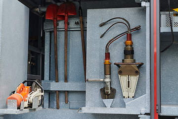 Image showing Close-up of essential firefighting equipment on a modern firetruck, showcasing tools and gear ready for emergency response to hazardous fire situations