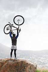 Image showing Back, success and a man with a bike on the mountains for training achievement or pride. Nature, fitness and a male biker on a cliff or hill with a bicycle for an exercise, fitness or competition win