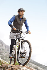 Image showing Thinking, fitness and a man on a bike on the mountain for cycling, training and travel in nature. Idea, health and a male biker on a hill with a bicycle for sports, exercise and an outdoor workout