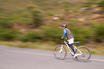 Image showing Man, mountain bike and cycling on road for nature adventure, speed or outdoor extreme sports. Male person or cyclist on bicycle for fast cardio, street or uphill in exercise, practice or training