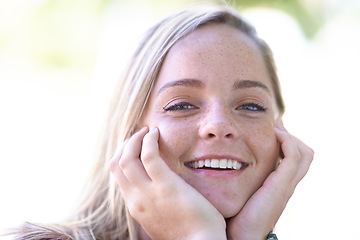 Image showing Portrait, happy and beauty of woman outdoor, touch skin and facial expression in summer. Smile, face and hands of blonde female person, natural and confidence of young girl in nature in Switzerland