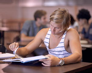 Image showing University, reading and man in library with books for studying, learning and research with knowledge. Education, college and male student with textbooks for assignment, project and test on campus