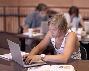 Image showing Education, laptop and man with books for studying, learning and research for knowledge. University, college and student with computer and textbooks for assignment, project and test in campus library