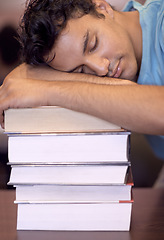 Image showing Student man, sleeping and stack of books for education, development or exhausted with fatigue at college library. Person, learning and rest with burnout, tired or mental health for exam at university