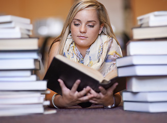 Image showing Woman, library and reading book on floor for literature, learning or knowledge at bookstore. Young female person, bookworm or student looking at information for story, research or study of author