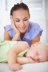 Image showing Sweet, sleeping and mother with baby on bed for bonding, relax and happy cute relationship. Love, smile and young mom watching girl child, kid or toddler taking a nap in bedroom or nursery at home.