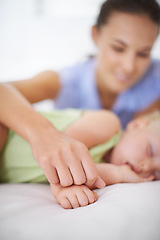 Image showing Hands, sleeping and mother with baby on bed for bonding, relax and sweet cute relationship. Happy, smile and young mom watching girl child, kid or toddler taking a nap in bedroom or nursery at home.