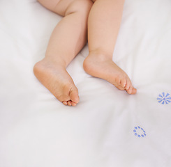 Image showing Baby sleeping, feet and top view on bed to relax, comfort and calm at home on mockup space. Toddler, above and closeup of cute foot, legs of adorable child and young kid resting in peace in bedroom