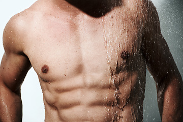 Image showing Closeup, muscular man or wet with body, hygiene or fitness with abs, routine or wellness on studio background. Person, guy or model with water, bodybuilder or cleaning with energy, chest or aesthetic