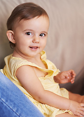 Image showing Baby, portrait and sitting on couch, child development and infant growth with face, happy and home. Girl, joyful and healthy in good mood, childhood and cheerful with enthusiasm, kid and adorable